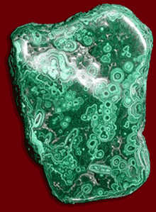 Malachite is a semi-precious stone and is formed from copper containing solutions in or near copper ore deposits.