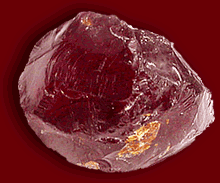 The name garnet is believed to have come from the pomegranate, a fruit which features deep red-purple seeds.